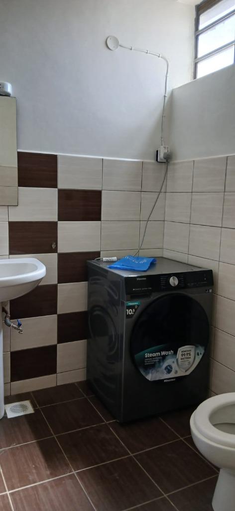 Front-loading washing machine professionally installed and plumbed by LAWADOSI technical team