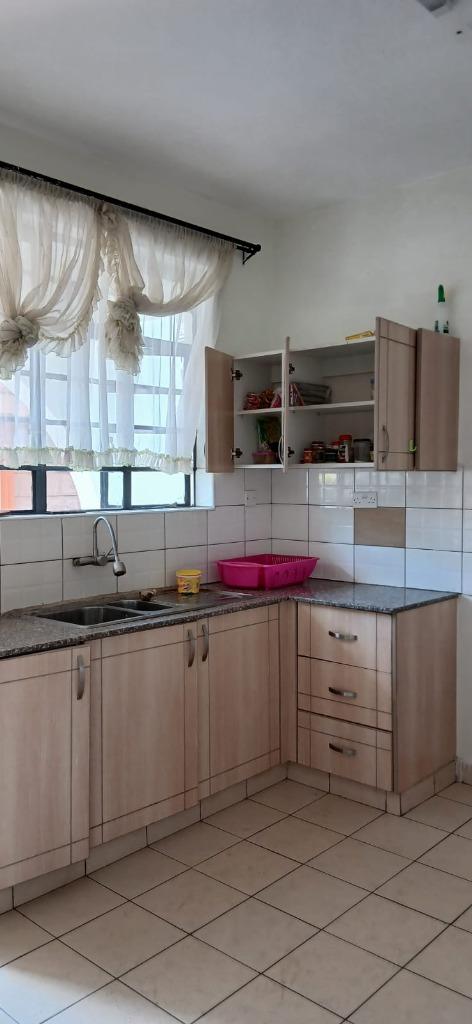 Neatly organized kitchen cupboards and clean countertops after unpacking by LAWADOSI Movers