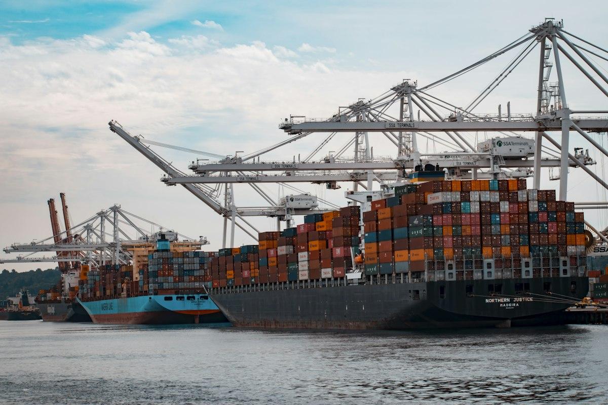 Shipping containers being loaded onto a freighter at an international port terminal